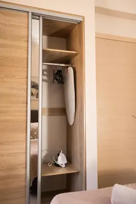 a bedroom with a closet with a mirror at Plakoures Home in Kounoupidhianá