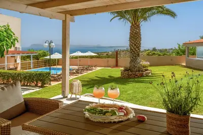 a table with a tray of food and two drinks at Villa Aretousa 1 in Agia Marina Nea Kydonias