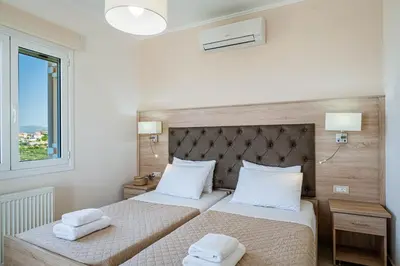a bedroom with two beds with towels on them at Villa Aretousa 1 in Agia Marina Nea Kydonias
