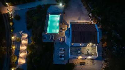 an overhead view of a swimming pool at night at Villa di Lusso Agave con Piscina Privata Riscaldata e Jacuzzi in Litsárdha