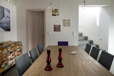 a dining room table with red vases on it at Villa di Lusso Agave con Piscina Privata Riscaldata e Jacuzzi in Litsárdha