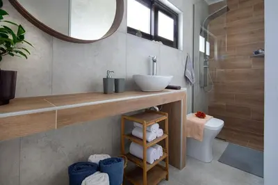 a bathroom with a sink and a toilet and a mirror at Santy Villa - Gerani in Gerani Chanion