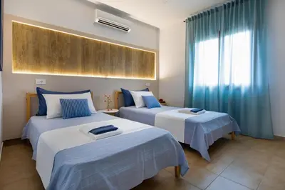 two beds in a room with blue and white at Santy Villa - Gerani in Gerani Chanion