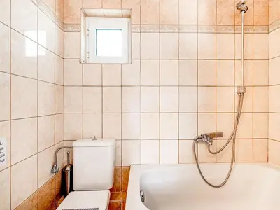 a bathroom with a shower and a toilet and a tub at Villa in Kalamitsi near White Mountains in Kalamítsion Alexándrou
