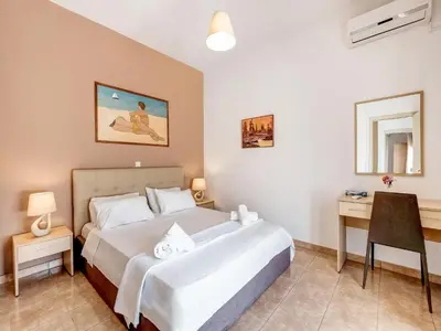 a bedroom with a bed and a desk in it at Villa in Kalamitsi near White Mountains in Kalamítsion Alexándrou