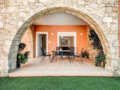 an archway leading to a patio with a table and chairs at Villa in Kalamitsi near White Mountains in Kalamítsion Alexándrou
