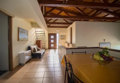 a kitchen with a table with a bowl of fruit on it at Ktima Nikolaos in Arónion