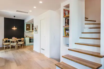 a kitchen and dining room with a staircase in a house at Happy Villa in Kato Galatas