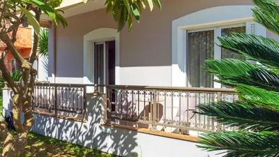a balcony of a house with palm trees at Vakakis-ME Apartments in Palaiochóra