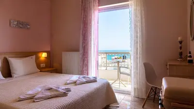 a hotel room with a bed and a large window at Vakakis-ME Apartments in Palaiochóra