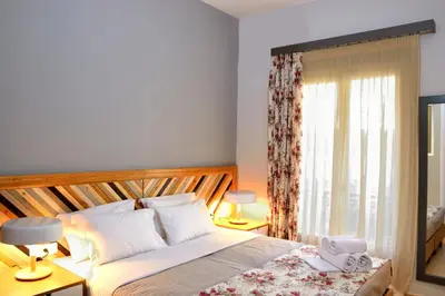 a bedroom with a large bed and a window at Elia Dorotheou in Chania Town