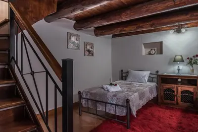 a bedroom with a bed and a staircase at Villa Fabrica in Thimiá