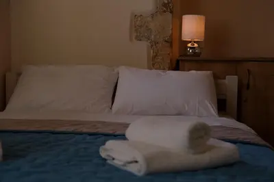 a bedroom with a bed with towels on it at Fivos Pension in Chania Town