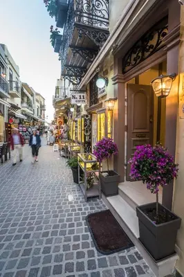 a street with some flowers inpots on the sidewalk at 11City Rooms in Chania Town