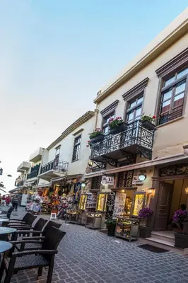 a city street with tables and chairs and buildings at 11City Rooms in Chania Town