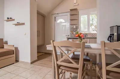 a kitchen and dining room with a table and chairs at Grameno Apartments in Kountoura Selino