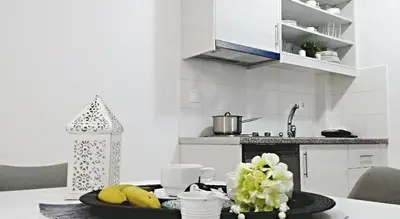 a kitchen with a table with a tray of fruit on it at Crown Apartments in Kalyves