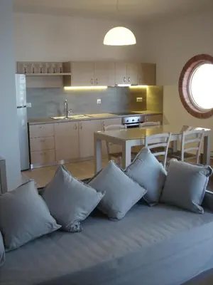 a living room with a couch with pillows at Villa-Palaiochora in Palaiochóra