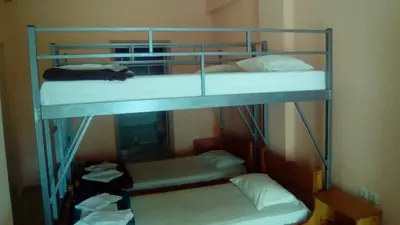 two bunk beds in a room with towels at Constantinos Budget Beds in Chania Town