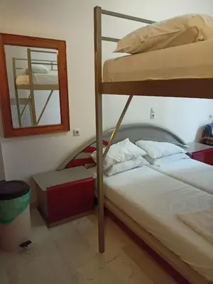 a bedroom with two bunk beds and a mirror at Constantinos Budget Beds in Chania Town