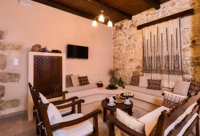 a living room with a couch and a table at Alia Stone Villa-Ideal for families-Heated pool in Nohia