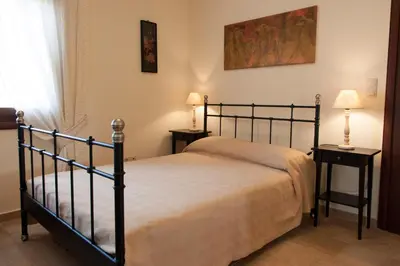 a bedroom with a bed and two night stands at Villa Allegra in Korfalónas