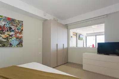 a living room with a tv and a couch at Stefan's City Loft in Chania Town