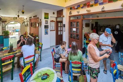 a group of people sitting in a restaurant at Poco Loco Bed & Breakfast in Chania Town
