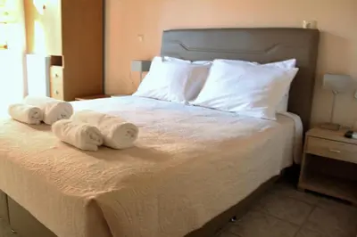 a bedroom with a bed with two towels on it at My Rooms in Chania Town