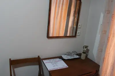 a room with a table and a mirror on a wall at My Rooms in Chania Town