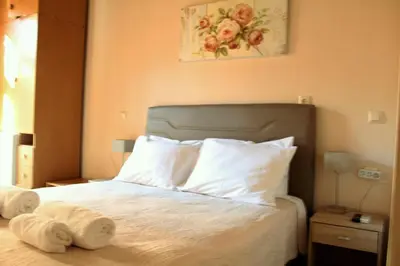a bedroom with a bed with two towels on it at My Rooms in Chania Town