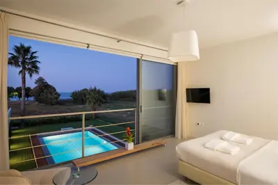 a bedroom with a view of a swimming pool at Blue Sea Luxury Villa in Maleme