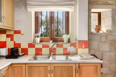 a kitchen with a sink and a window at Stone Built Private villa Emerald with pool, 30m to Beach & BBQ! in Ropanianá