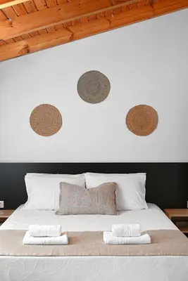 a bedroom with a white bed with two towels on it at Villa Felenia in Vryses
