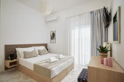 a bedroom with a bed and a large window at Villa Felenia in Vryses