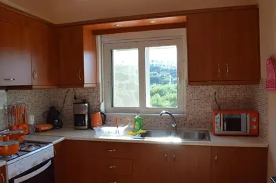 a kitchen with a sink and a window at Angellinas Apartments in Kato Daratso