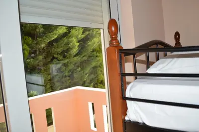 a bedroom with a bunk bed and a window at Angellinas Apartments in Kato Daratso