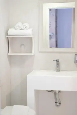 a bathroom with a sink and a mirror and towels at Elia in Kavoúsion