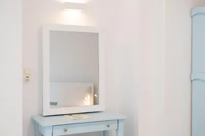 a mirror on top of a blue dresser in a room at Elia in Kavoúsion