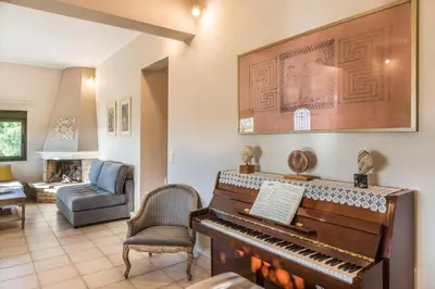 a living room with a piano and a couch at Aoria Villa By Hope Estate in Arménoi