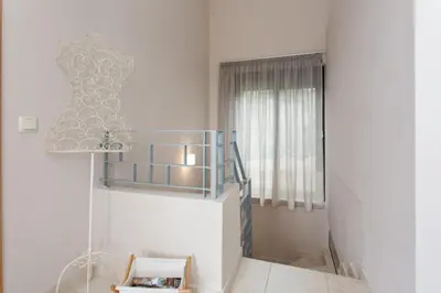 a room with a lamp and a dress on the wall at Aoria Villa By Hope Estate in Arménoi