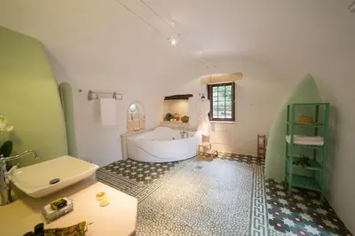 a bathroom with a white tub and a sink at Villa Bliss in Kounoupidhianá