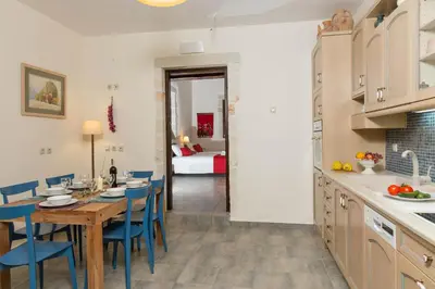 a kitchen and dining room with a table and chairs at Villa Bliss in Kounoupidhianá