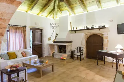 a living room with a couch and a fireplace at Villa Bliss in Kounoupidhianá