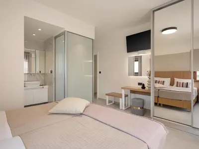 a bedroom with a large bed and a bathroom at Elia Seaside in Chania Town