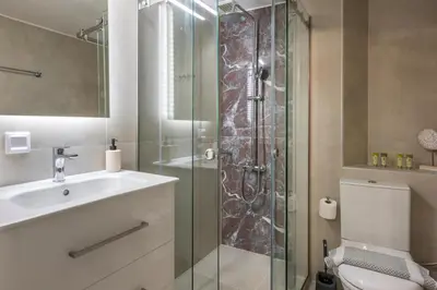 a bathroom with a shower and a sink and a toilet at Porto Orion Studios in Chania Town