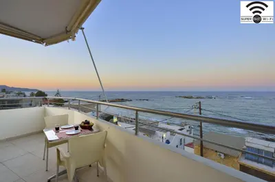 a balcony with a table and chairs on a cruise ship at Kalamaki Apartments in Kalamaki Chanion