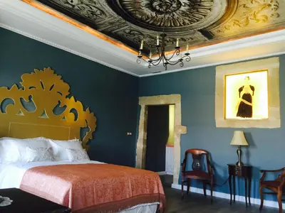 a bedroom with a bed and a ceiling at Cretan Renaissance in Chania Town