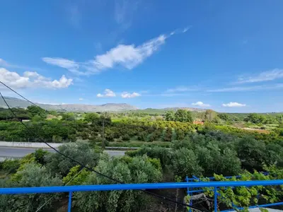 a view of the countryside from the balcony of a house at Iliana's Bungalow in Arménoi
