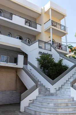 a building with stairs in front of it at Manias Hotel Apartments in Agia Marina Nea Kydonias
